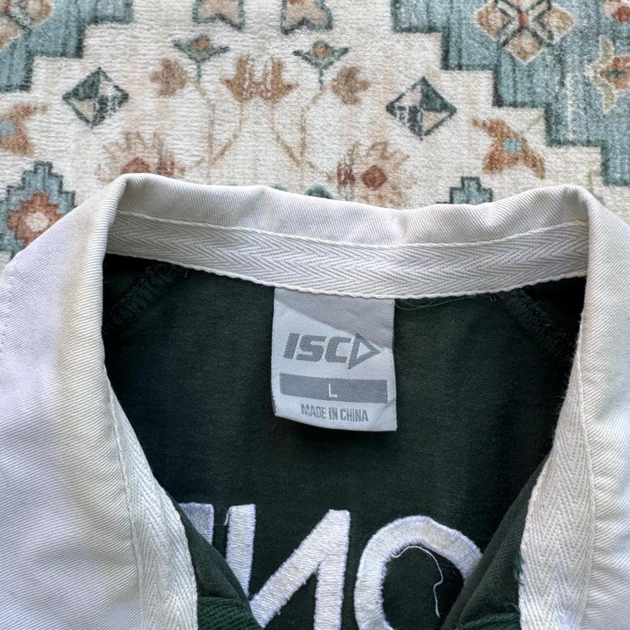 ISC green rugby polo shirt with embroidered London Irish logo and slim fit.