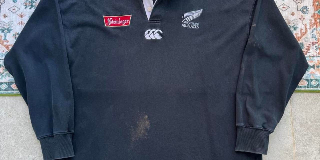 Canterbury men's polo shirt black with All Blacks logo and rugby pattern details.