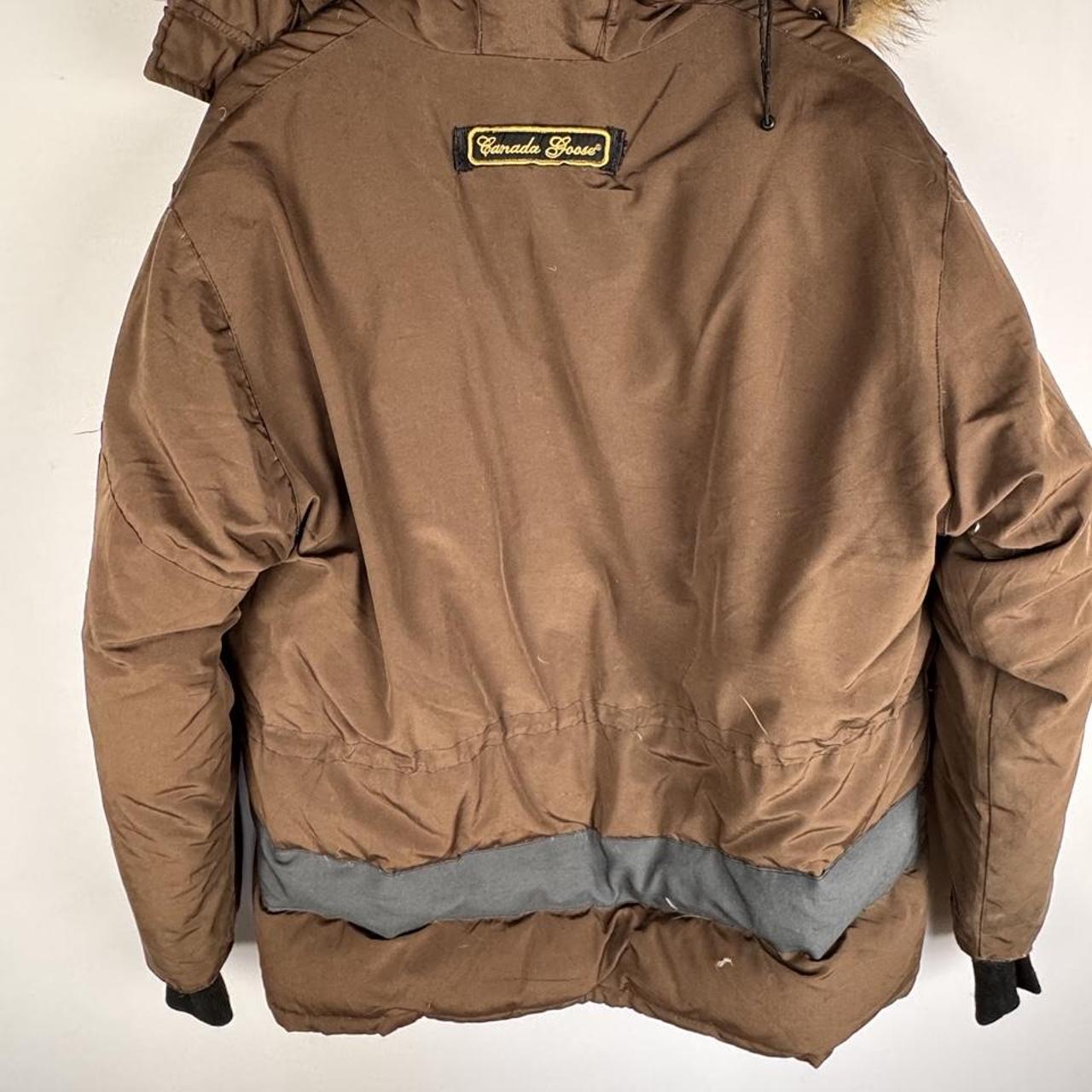 Canada Goose brown parka jacket with logo patch and utility pockets.
