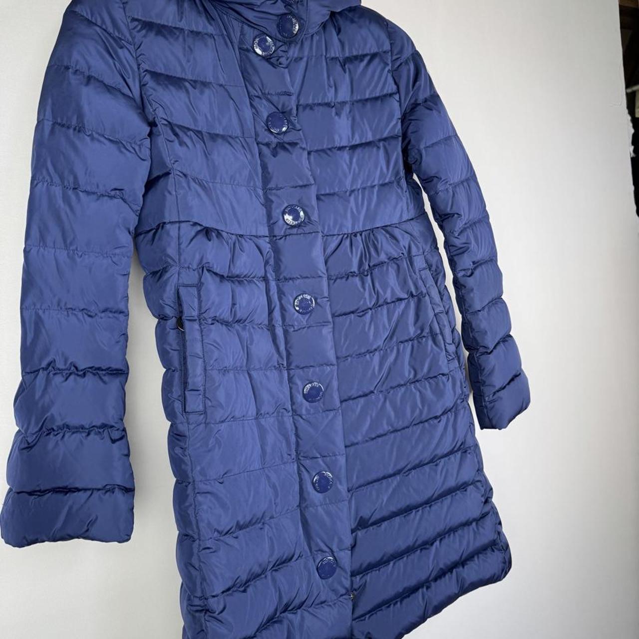 Moncler blue puffer jacket with logo detail and quilted design.