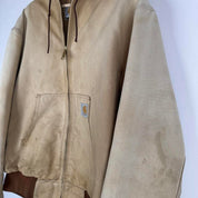 Carhartt cream distressed active jacket with logo patch and relaxed fit.