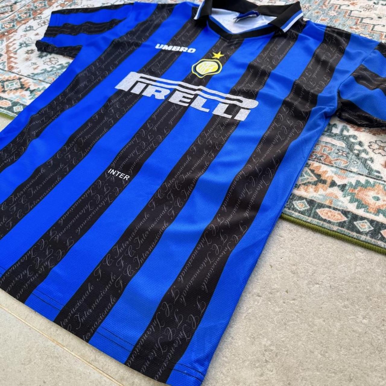 Umbro blue and navy striped home jersey with embroidered logo and vintage design.