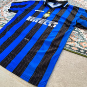 Umbro blue and navy striped home jersey with embroidered logo and vintage design.