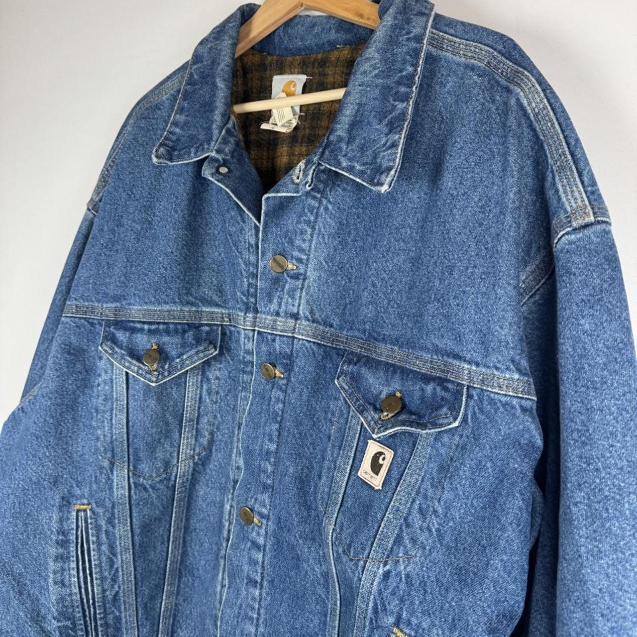 Carhartt denim trucker jacket 1990s style with classic logo and relaxed fit.
