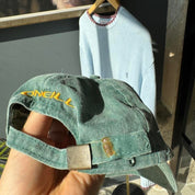 O'Neill green surf cap with vintage logo and adjustable strap.
