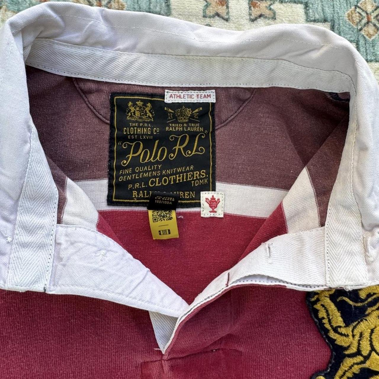 Polo Ralph Lauren burgundy rugby polo shirt with embroidered athletic team logo.