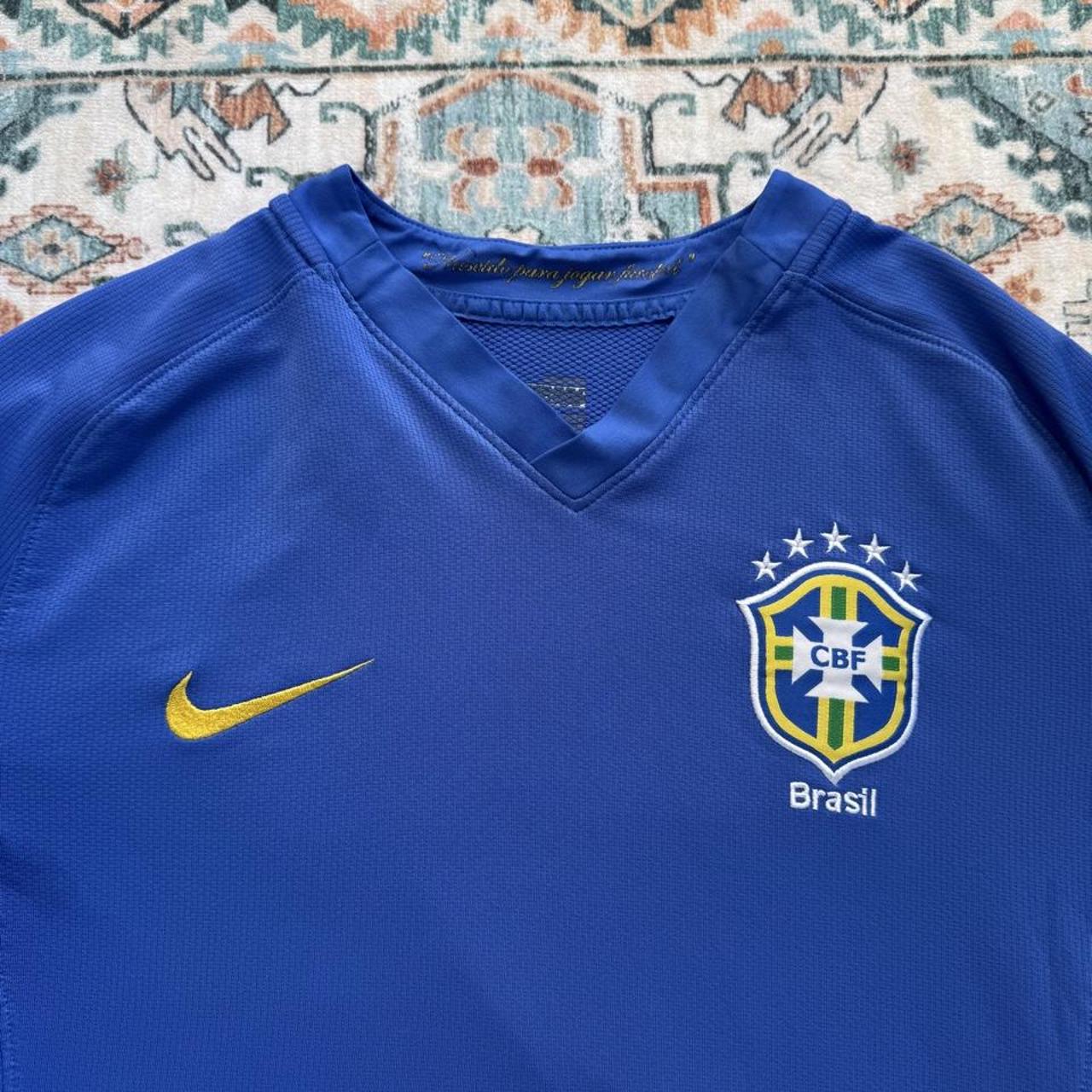 Nike blue Brazil away jersey with logo and classic design details.
