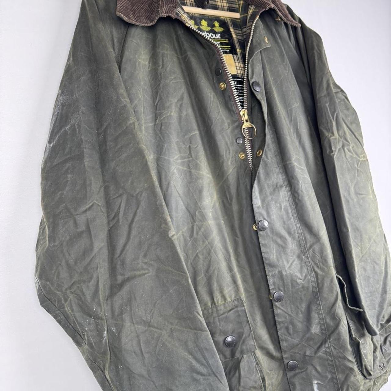 Barbour green waxed Beaufort jacket with attached hood and classic logo detail.