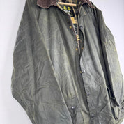 Barbour green waxed Beaufort jacket with attached hood and classic logo detail.