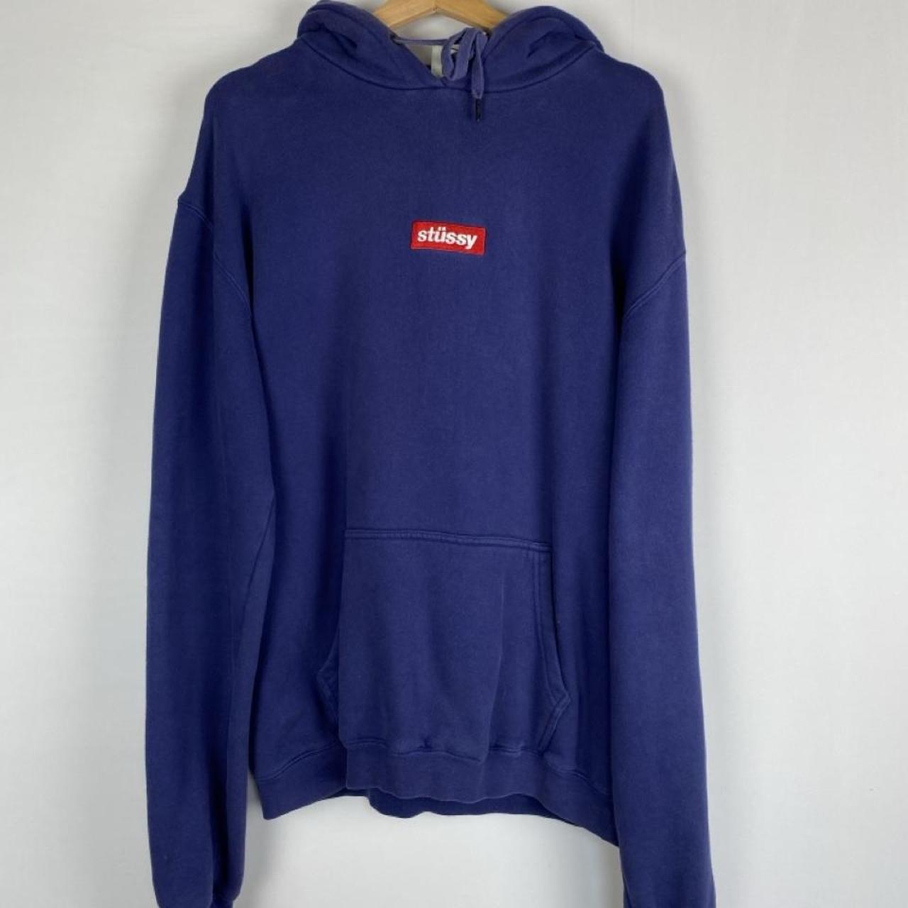 Stüssy blue oversized hoodie with embroidered box logo spellout on front.