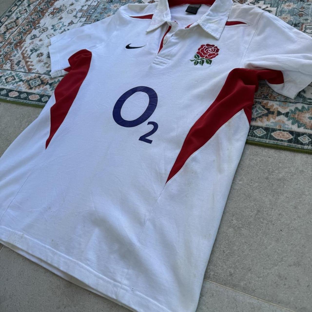 Nike England rugby polo shirt, red with embroidered logo and white collar details.