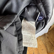 Canada Goose black parka jacket with logo patch and fur-lined hood.