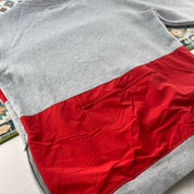 Stüssy grey sweatshirt featuring international logo and soft cotton material.