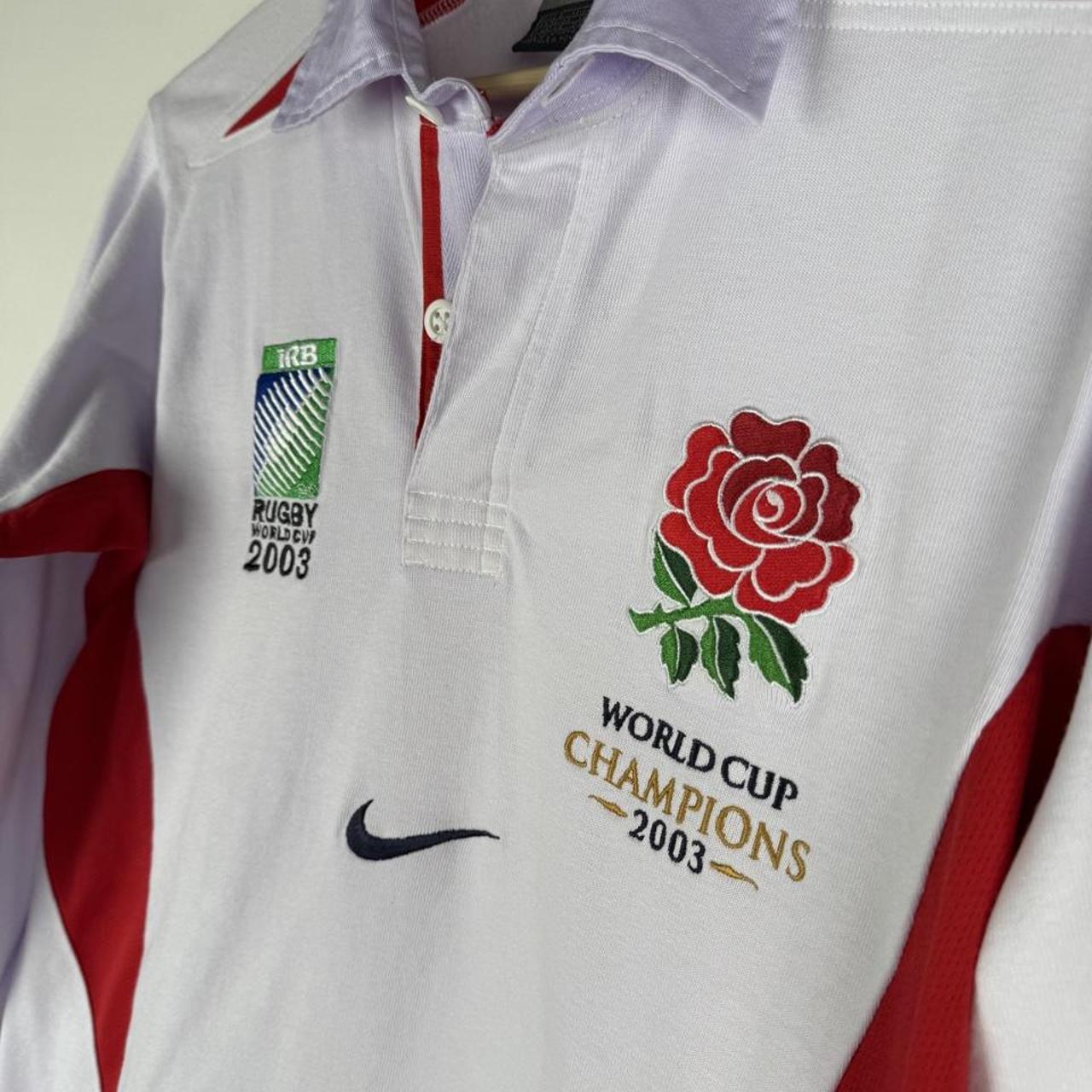 Nike men's polo shirt white with embroidered England Rugby logo and World Cup details.