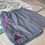 Nike ACG grey cargo training shorts with multiple pockets and logo detail.