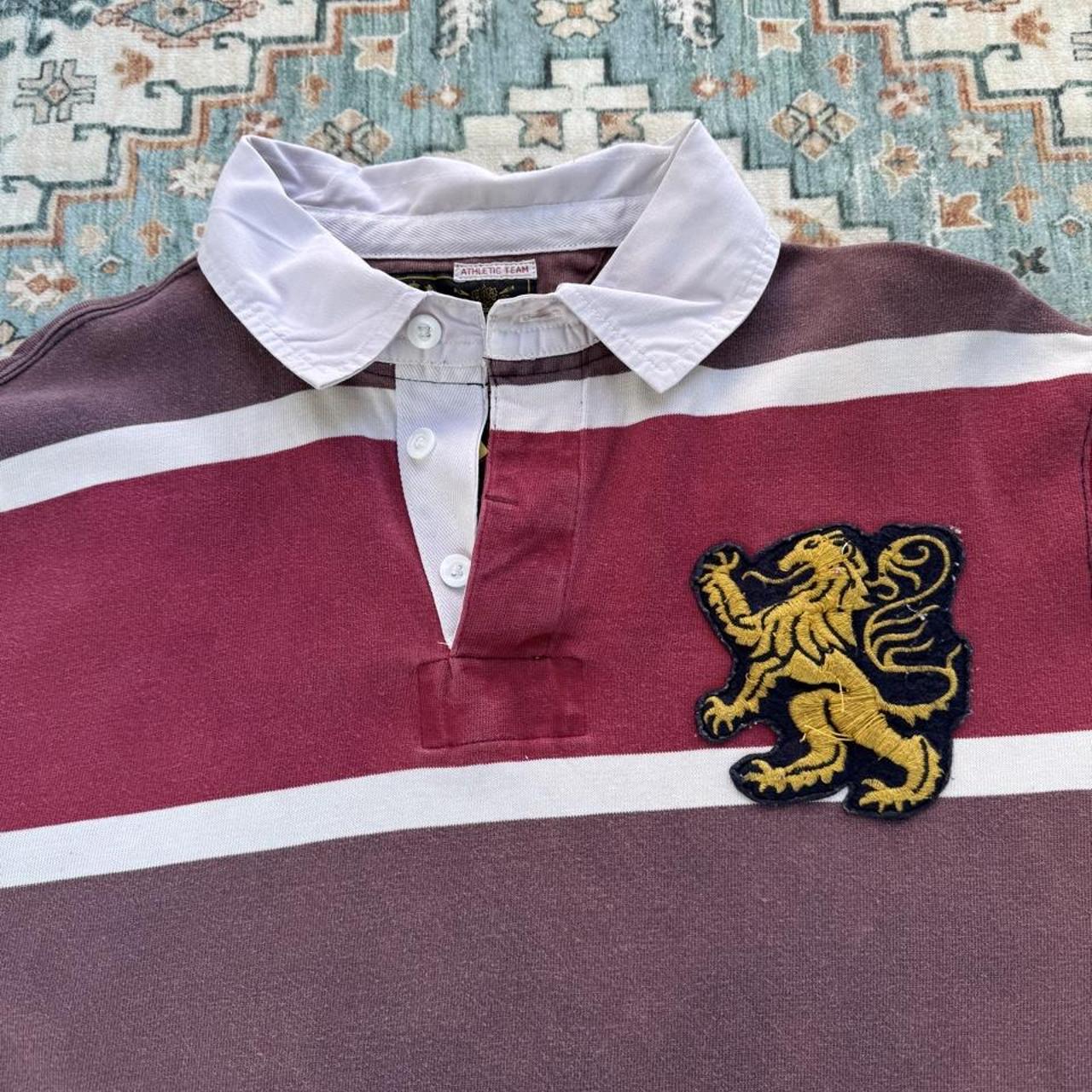 Polo Ralph Lauren burgundy rugby polo shirt with embroidered athletic team logo.