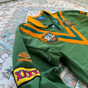 Umbro men's polo shirt green with Wallabies logo and rugby league pattern.