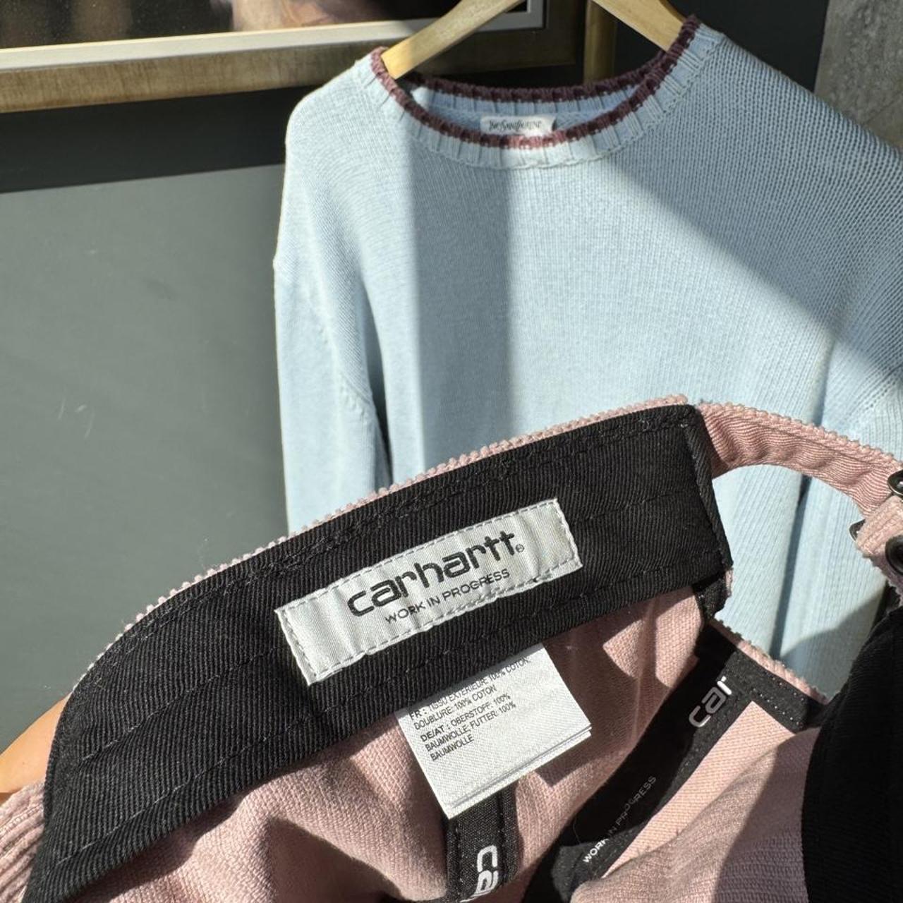 Carhartt WIP pink corduroy cap with embroidered Harlem logo detail.