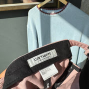 Carhartt WIP pink corduroy cap with embroidered Harlem logo detail.