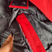 Canada Goose red parka jacket with logo patch and thick insulated material.