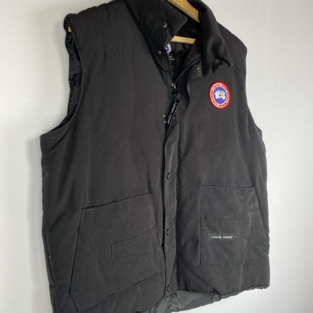 Canada Goose black down filled gilet with logo patch and zippered pockets.