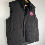 Canada Goose black down filled gilet with logo patch and zippered pockets.