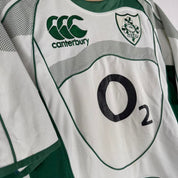 Canterbury green rugby shirt with embroidered Ireland logo and classic collar design.