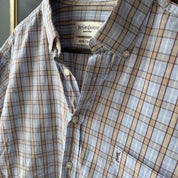 Yves Saint Laurent cream striped cropped shirt with logo detail and soft fabric.