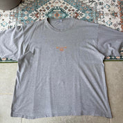 Billabong oversized graphic t-shirt blue with cream and green patterns, featuring pocket detail.